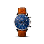 front view of wrist watch with blue face and steel body and tan leather strap